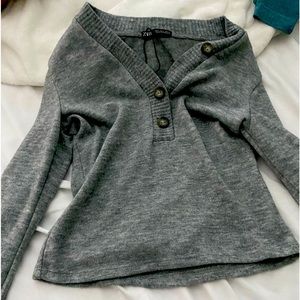 a grey button up sweater
